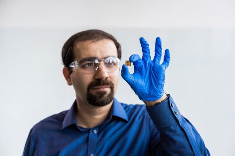 Associate Professor Mojtaba Abdi-Jalebi with a small prototype of photovoltaic cells optimized for indoor light. Image Credit: UCL / James Tye.