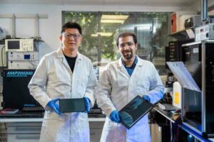 Associate Professor Mojtaba Abdi-Jalebi and PhD candidate Siming Huang with panels of their solar cells optimized for indoor light. Image Credit: UCL / James Tye.
